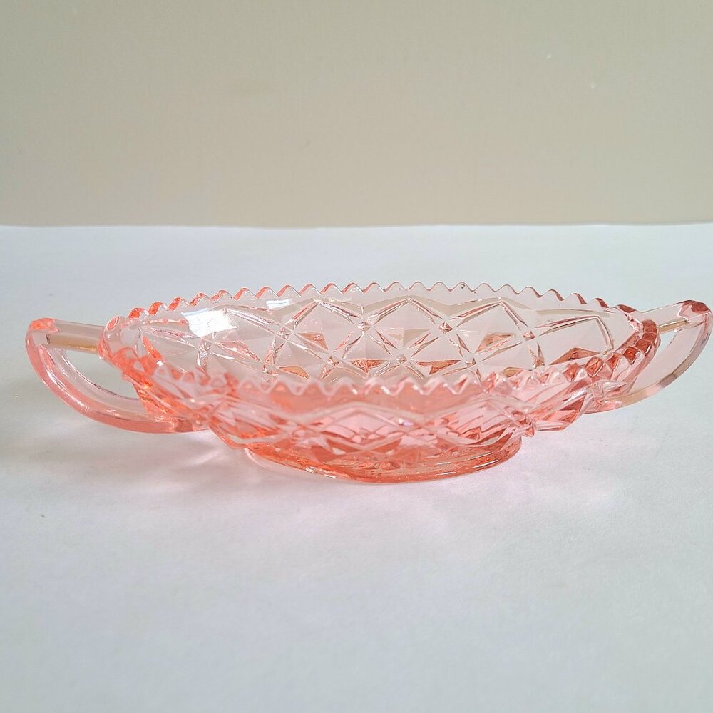 Pink depression glass bowl/candy dish with handles.